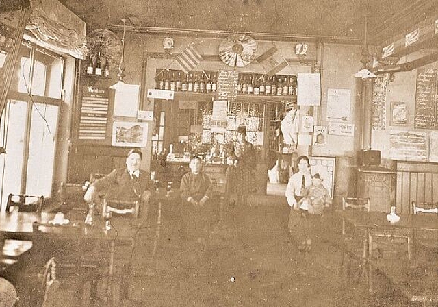 Die Gastube der Neuen Spanischen Weinhalle «Barcelona» 1923 mit der Wirtefamilie Francisco und Maria Marqués als Fotomotiv auf der Postkarte im Mai 1923.
