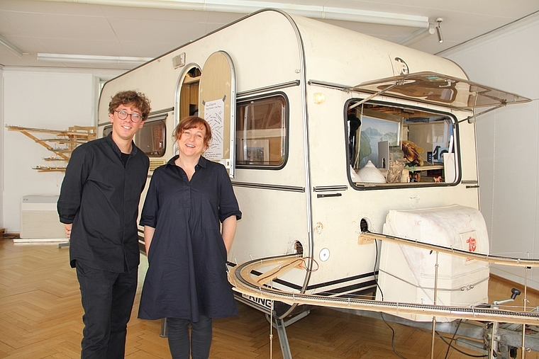Praktikant Lorenz Wiederkehr und Museumsdirektorin Dorothee Messmer vor dem TransK3Express-Wohnwagen. (Bild: mim)