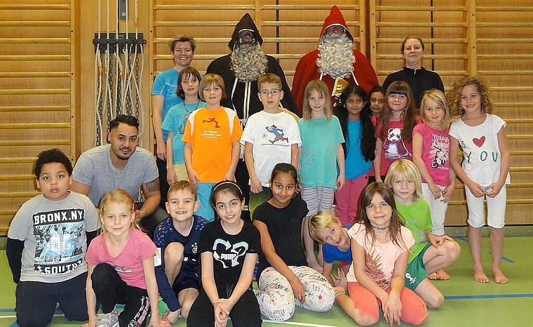 Nach dem Erinnerungsfoto mit Samichlaus und Schmutzli blieben strahlende Kinder der Jugi TV Olten im Sälischulhaus zurück. (Bild: ZVG)